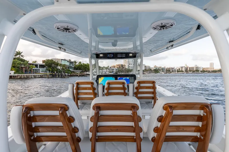 Slide: The Image of Interior view of 2026 Freeman 38 boat with luxurious seating and waterfront cityscape. - 48