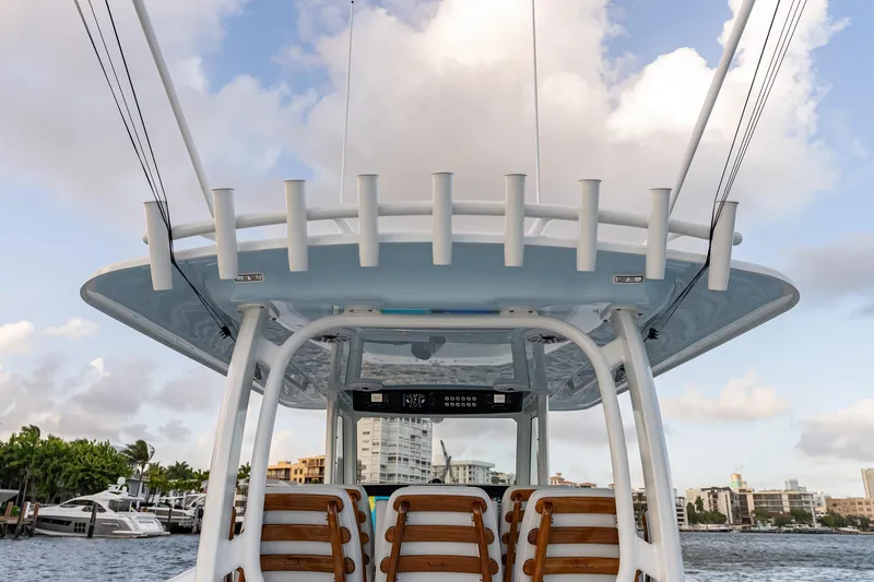 Slide: The Image of Freeman 38 boat, 2026 model, featuring rod holders and seating, against a waterfront cityscape. - 49