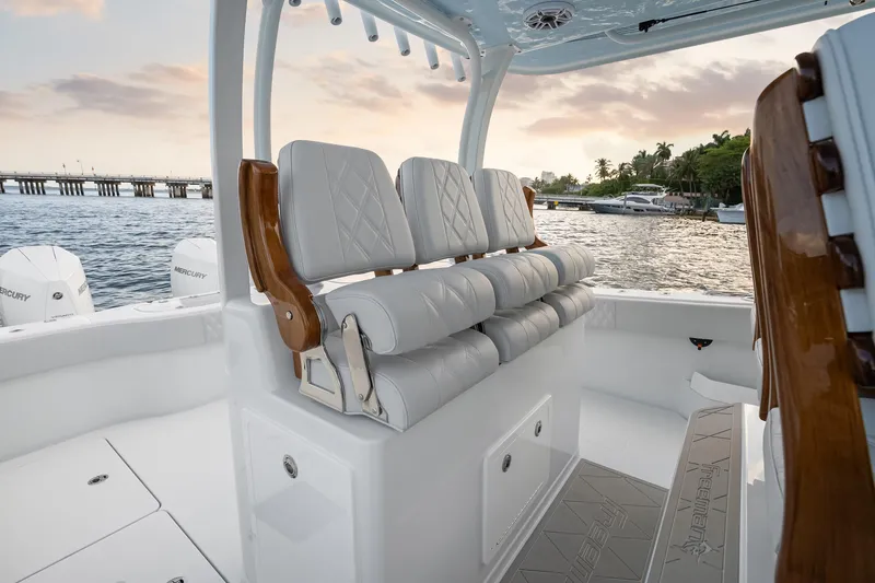 Slide: The Image of Luxury seating on a 2026 Freeman 38 boat, with scenic waterfront view at sunset. - 51