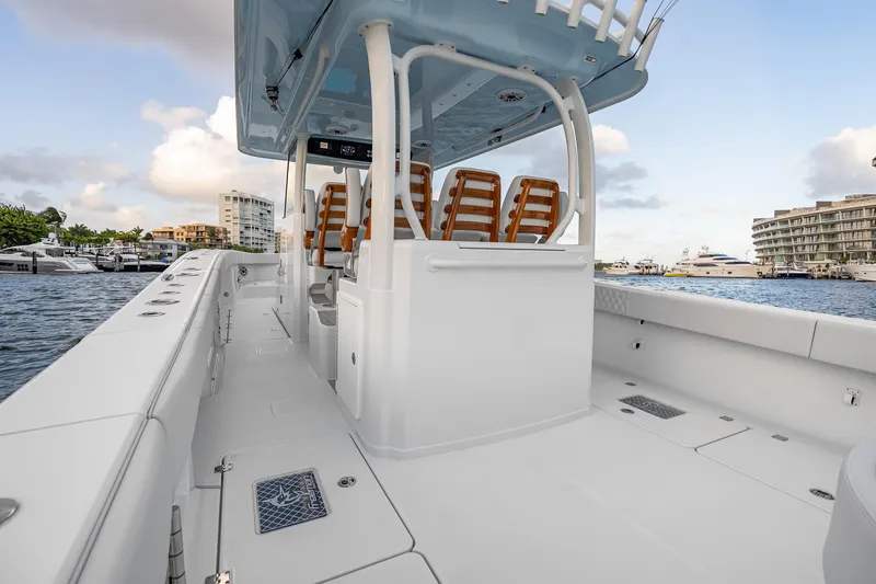 Slide: The Image of 2026 Freeman 38 boat interior with sleek design, docked near luxury yachts. - 53