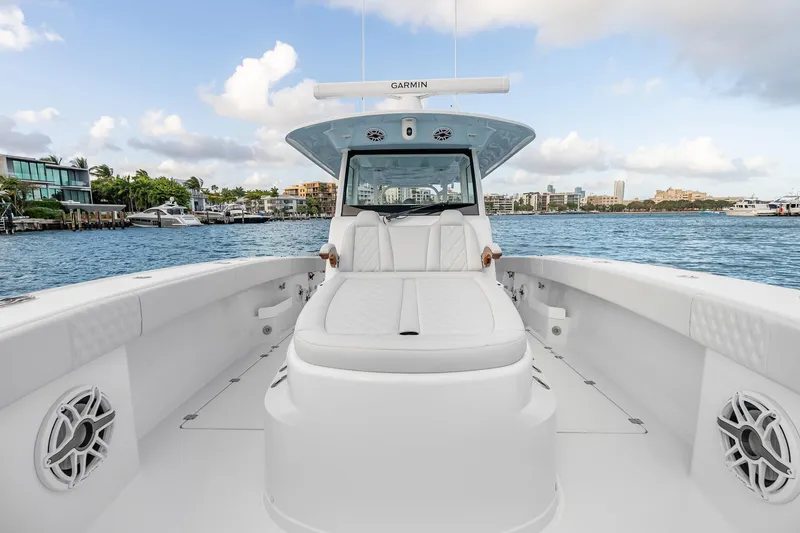 Slide: The Image of 2026 Freeman 38 boat with sleek white interior on a scenic waterfront. - 54