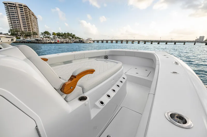 Slide: The Image of Luxurious 2026 Freeman 38 boat interior with elegant seating, docked near a scenic waterfront. - 56