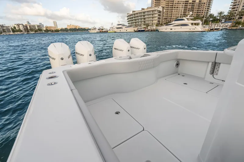 Slide: The Image of 2026 Freeman 38 boat with Mercury engines docked in a marina, surrounded by water and yachts. - 57