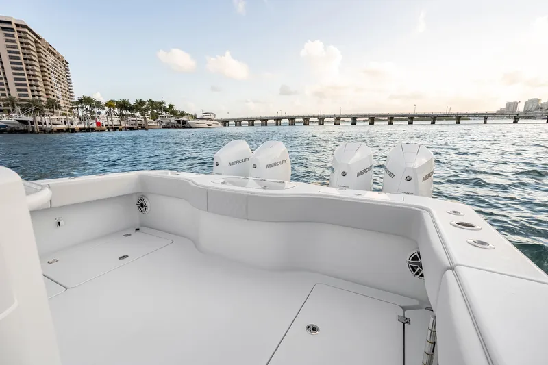 Slide: The Image of 2026 Freeman 38 boat with Mercury engines, docked near a bridge and waterfront buildings. - 58