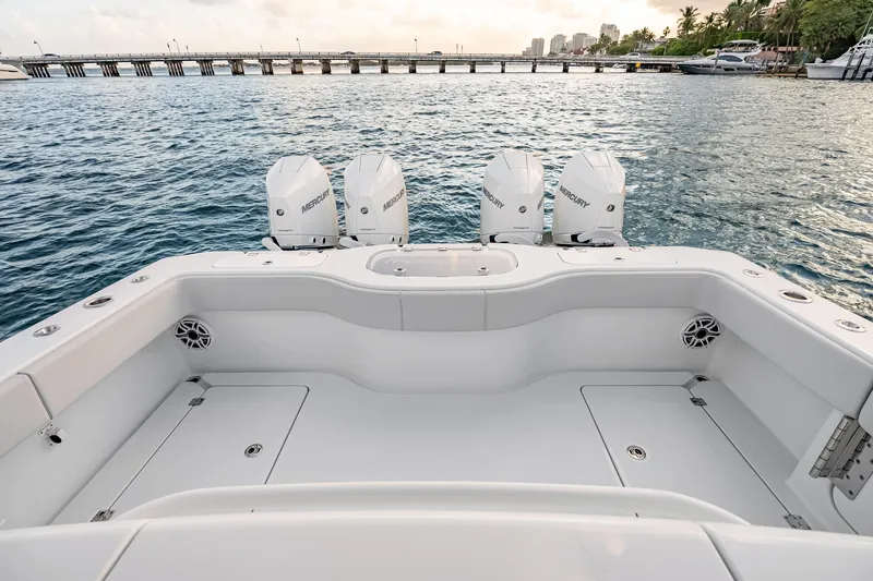 Slide: The Image of 2026 Freeman 38 boat with Mercury engines, docked near a scenic waterfront. - 59