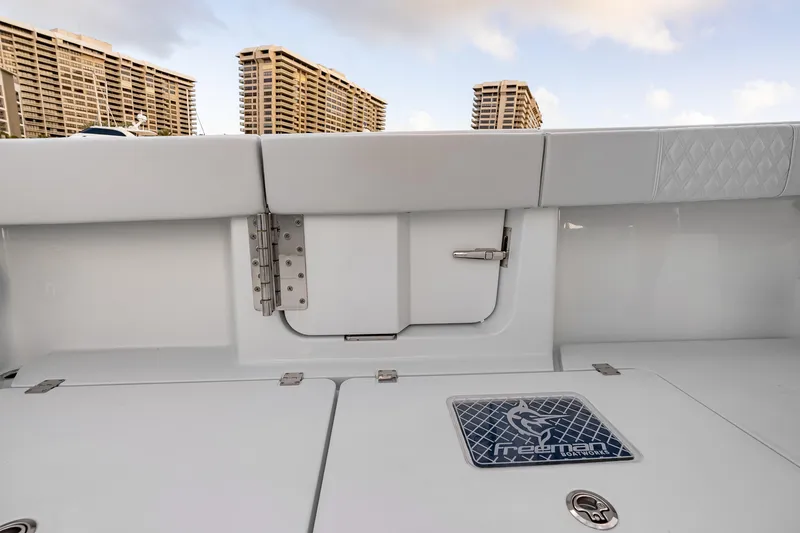 Slide: The Image of 2026 Freeman 38 boat interior with sleek white design and urban skyline backdrop. - 64