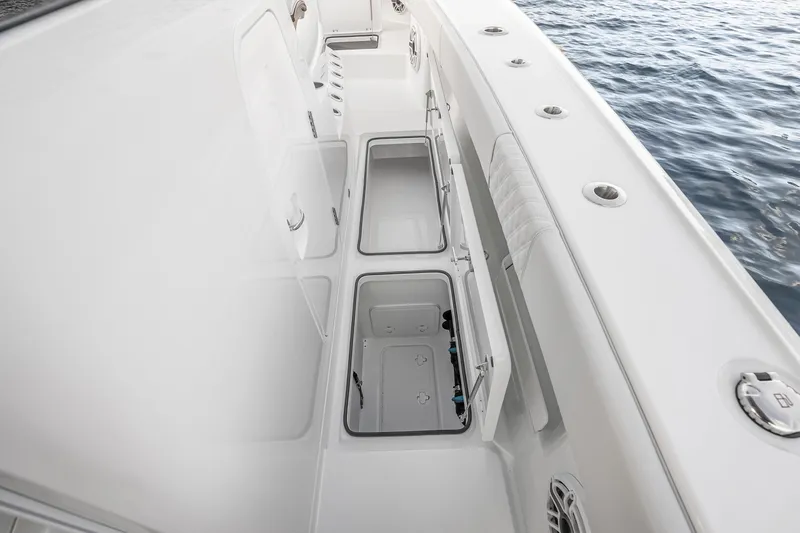 Slide: The Image of Freeman 38 boat interior with open storage compartments, 2026 model, near water. - 69