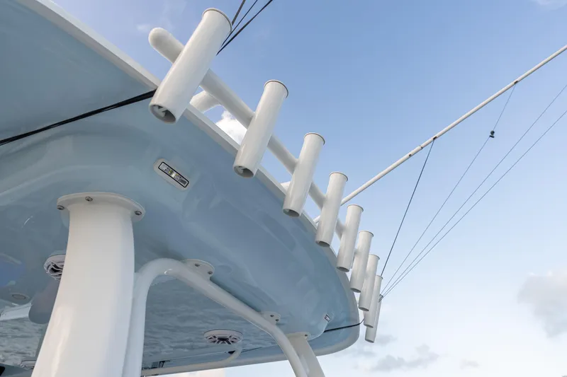 Slide: The Image of Freeman 38 boat, 2026 model, featuring rod holders against a clear blue sky. - 76