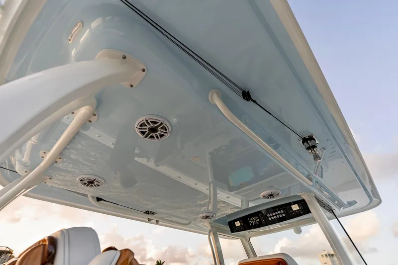 Slide: The Image of 2026 Freeman 38 boat interior, featuring speakers and control panel under a sleek canopy. - 77