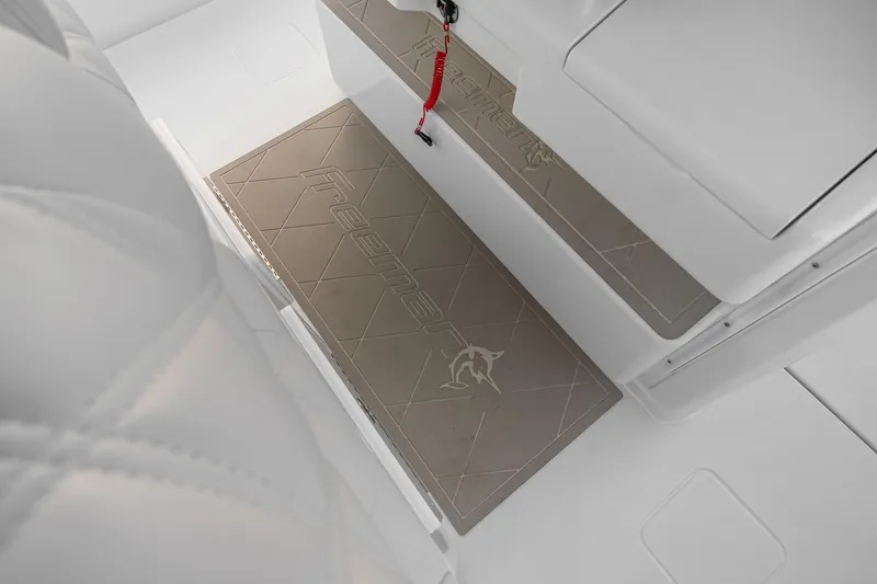 Slide: The Image of Interior of 2026 Freeman 38 boat featuring branded floor mats and sleek white design. - 79