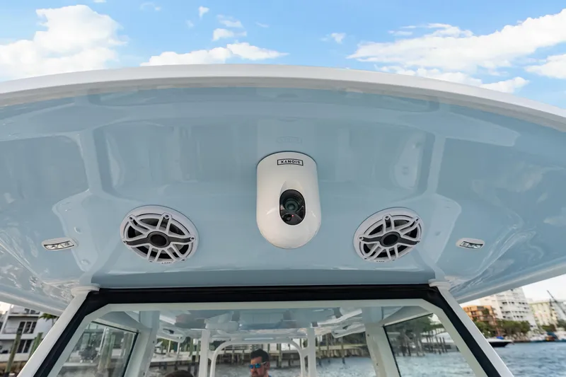 Slide: The Image of 2026 Freeman 38 boat roof with speakers and camera under clear sky. - 81