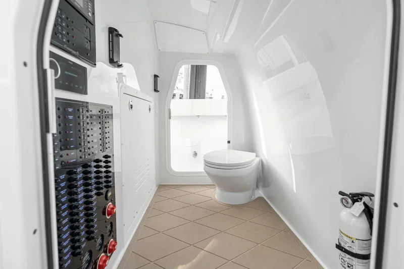 Slide: The Image of Modern Freeman 38 boat interior with toilet, control panels, and fire extinguisher, 2026 model. - 83