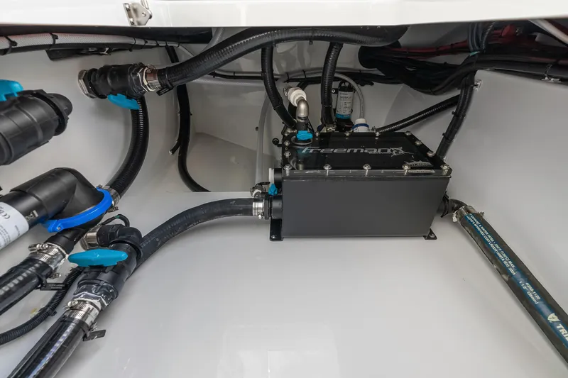 Slide: The Image of Freeman 38 boat engine compartment with hoses and components, 2026 model. - 86
