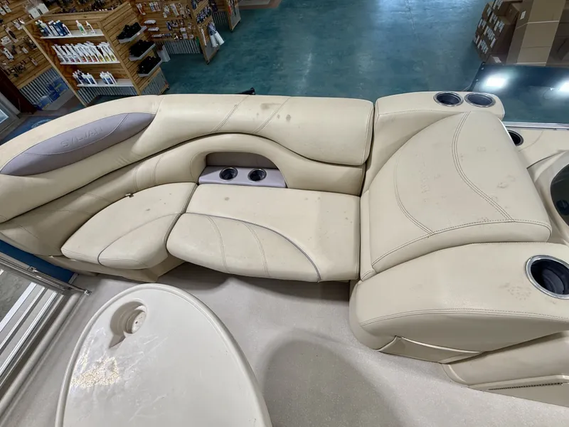 Slide: The Image of Interior of a 2017 Sylvan 8520 pontoon boat, beige seating, cup holders. - 16