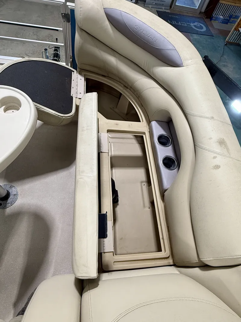 Slide: The Image of Interior of a Sylvan 8520 boat, seating with storage compartment. - 19