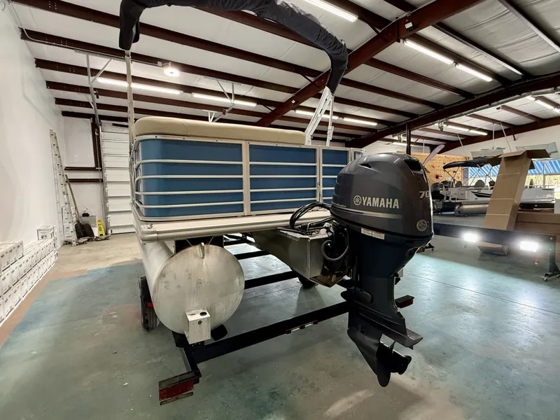 Slide: The Image of 2017 Sylvan 8520 pontoon boat with Yamaha motor in warehouse. - 8