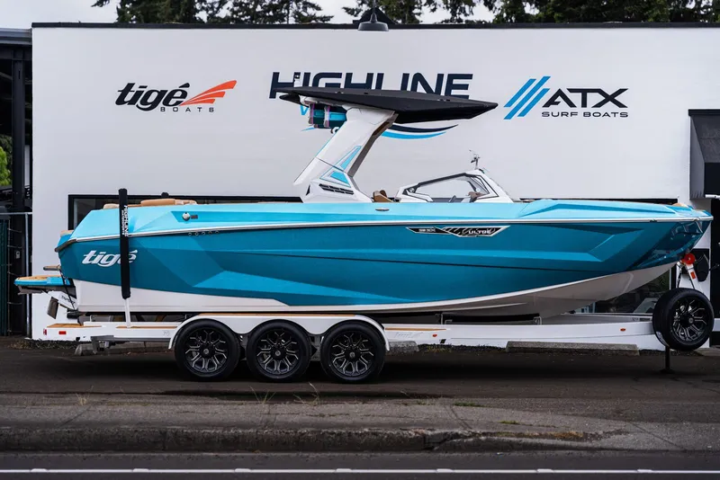 Slide: The Image of 2026 Tigé Ultré 25ZX boat in vibrant blue on trailer. - 4