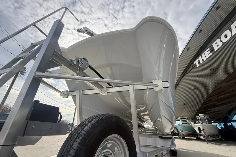 Slide: The Image of 2026 Twin Vee 280 GFX2 CC boat on trailer under cloudy sky. - 12