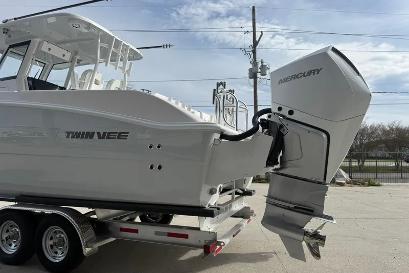 Slide: The Image of 2026 Twin Vee 280 GFX2 CC boat with Mercury outboard engine on trailer. - 13