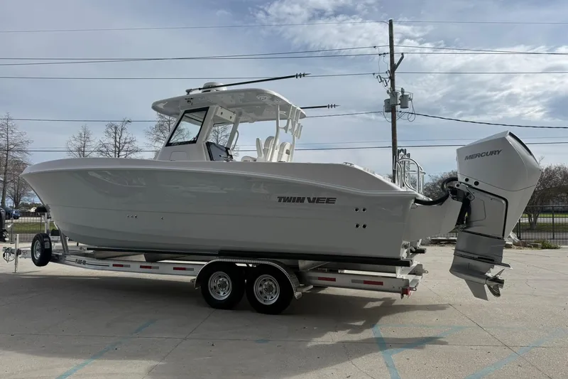 Slide: The Image of 2026 Twin Vee 280 GFX2 CC boat on trailer, featuring Mercury outboard engine. - 14