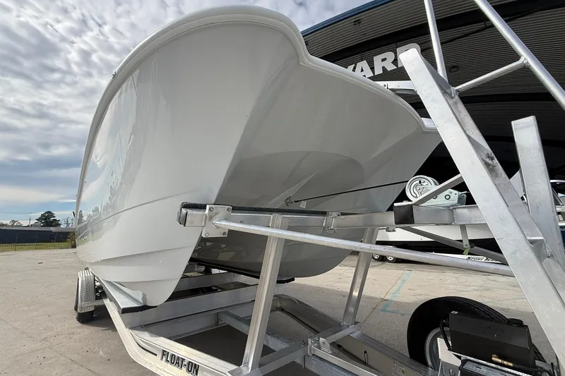Slide: The Image of 2026 Twin Vee 280 GFX2 CC boat on trailer, showcasing sleek hull design. - 16