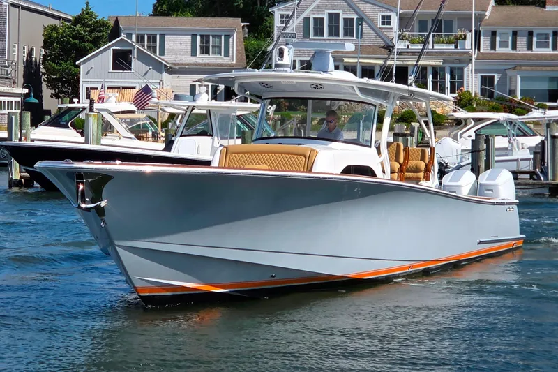 Slide: The Image of 2023 Valhalla Boatworks V-46 cruising in a marina, showcasing sleek design and luxury features. - 12