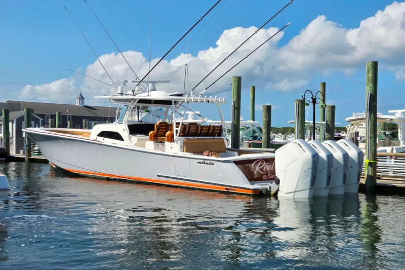 Slide: The Image of 2023 Valhalla Boatworks V-46 docked, featuring multiple outboard engines and sleek design. - 16