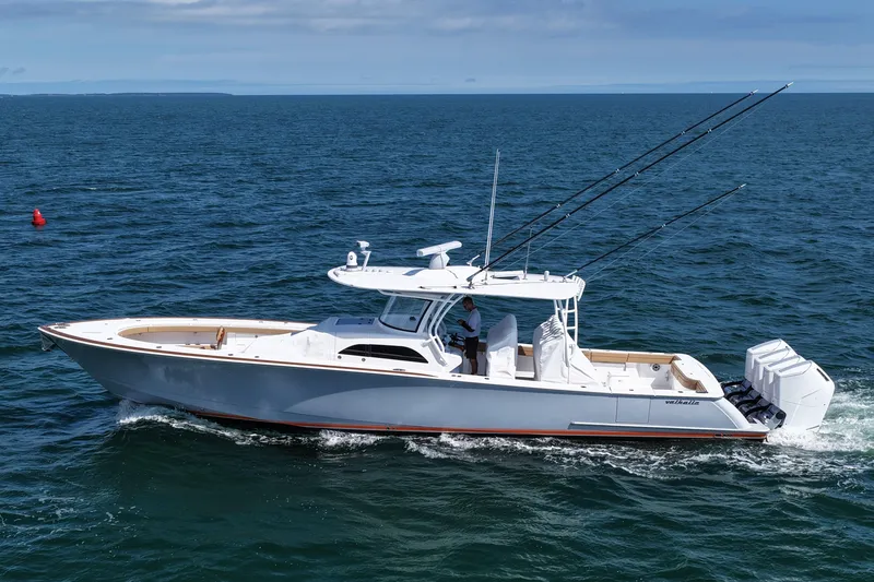 Slide: The Image of 2023 Valhalla Boatworks V-46 cruising on open water, featuring sleek design and powerful engines. - 2