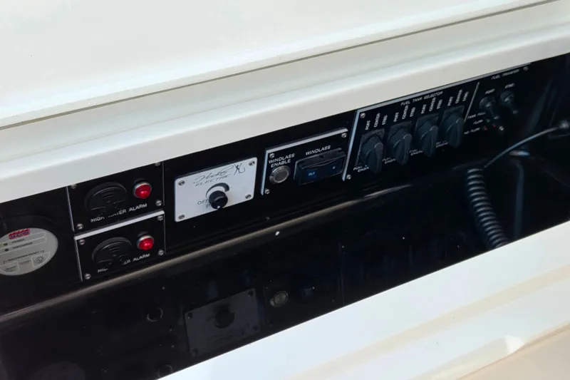 Slide: The Image of Control panel of 2023 Valhalla Boatworks V-46, featuring high water alarms and fuel tank selectors. - 24