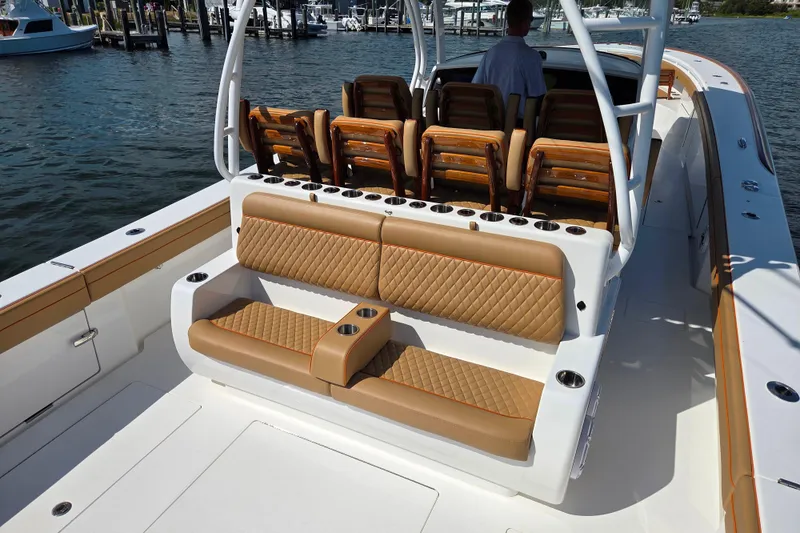 Slide: The Image of 2023 Valhalla Boatworks V-46 with luxurious tan seating, docked in a marina. - 28