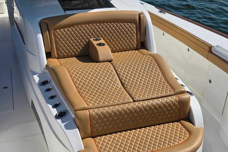 Slide: The Image of Luxurious tan seating on 2023 Valhalla Boatworks V-46, featuring diamond stitching and cup holders. - 34