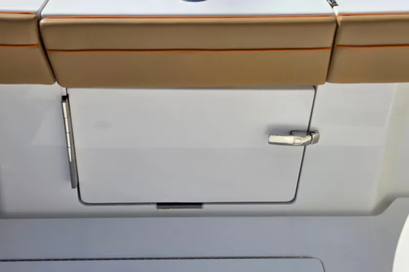 Slide: The Image of 2023 Valhalla Boatworks V-46 storage compartment with cushioned seating and sleek handle design. - 35