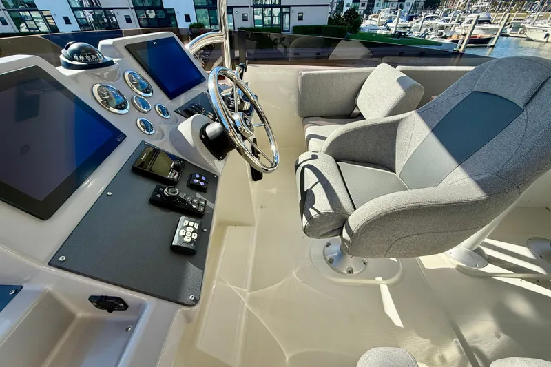 Slide: The Image of 2023 Beneteau Swift Trawler 48 helm with modern controls and comfortable seating. - 16