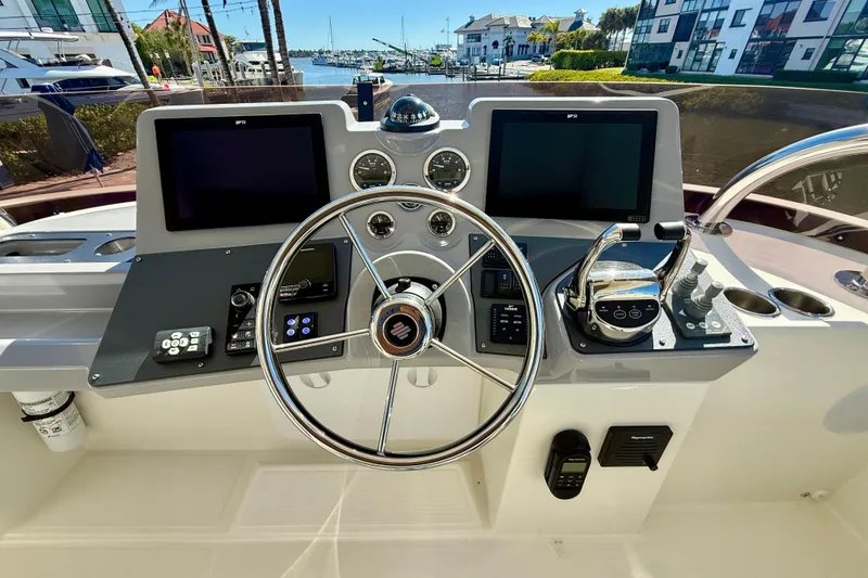 Slide: The Image of Helm of 2023 Beneteau Swift Trawler 48 with dual screens and modern controls. - 17