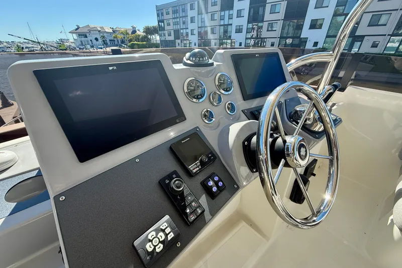 Slide: The Image of 2023 Beneteau Swift Trawler 48 helm with modern navigation displays and controls. - 18