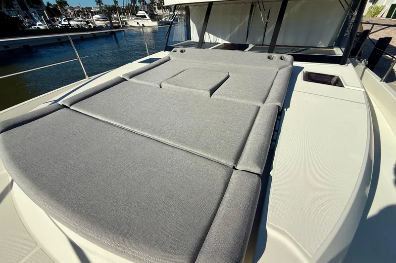 Slide: The Image of 2023 Beneteau Swift Trawler 48 with spacious sunbathing deck at marina. - 20