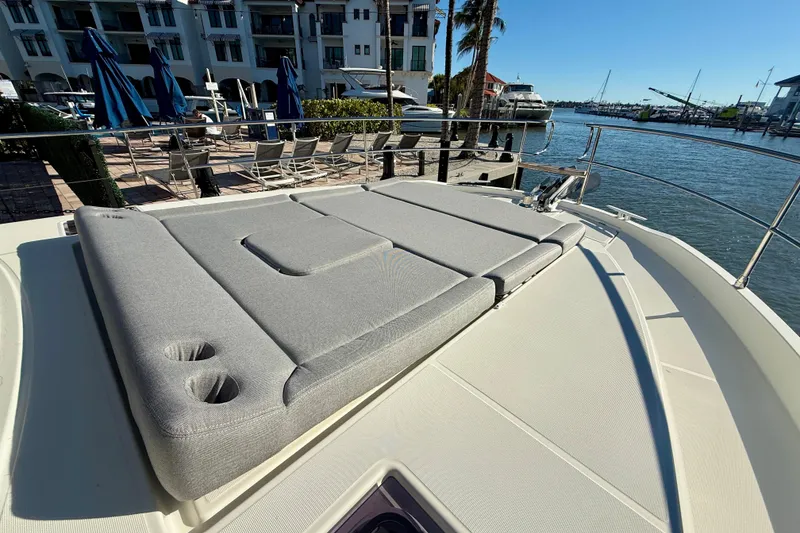 Slide: The Image of 2023 Beneteau Swift Trawler 48 with sunbathing deck, docked at marina. - 21
