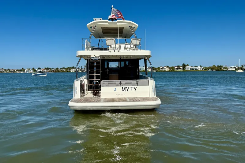 Slide: The Image of 2023 Beneteau Swift Trawler 48 cruising on a sunny day in Naples, FL. - 3