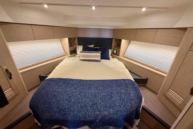 Slide: The Image of Luxurious bedroom interior of 2023 Beneteau Swift Trawler 48 with cozy bedding. - 34