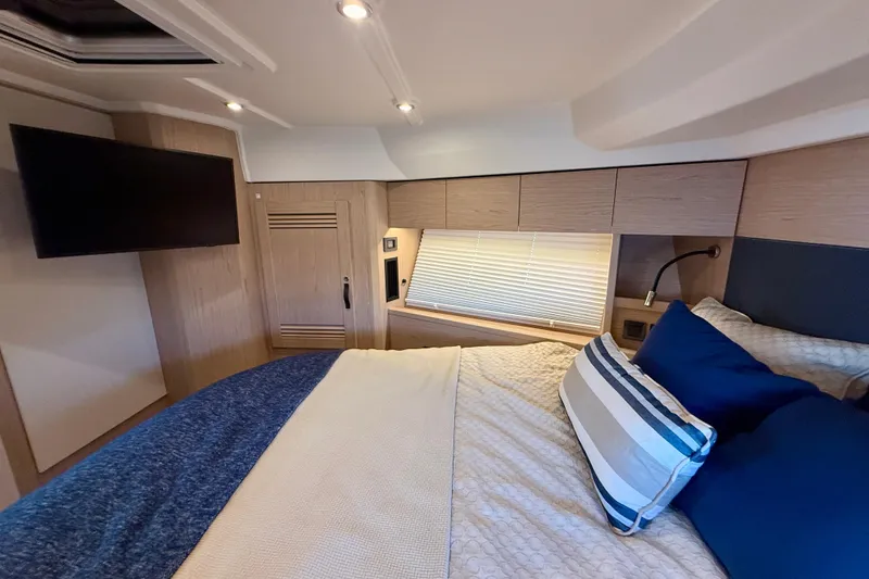 Slide: The Image of Luxurious bedroom interior of 2023 Beneteau Swift Trawler 48 with modern decor and amenities. - 35