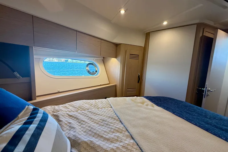 Slide: The Image of Luxurious cabin interior of 2023 Beneteau Swift Trawler 48 with ocean view. - 36