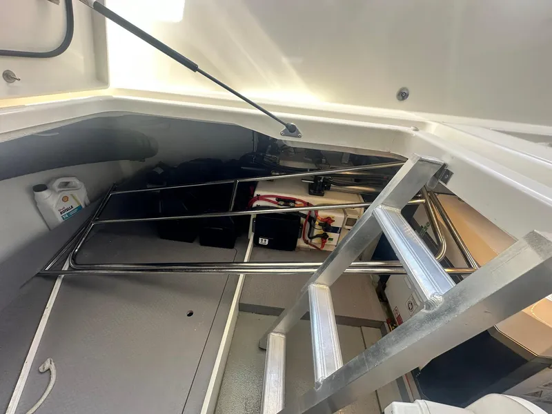 Slide: The Image of 2023 Beneteau Swift Trawler 48 interior storage area with ladder and equipment. - 41