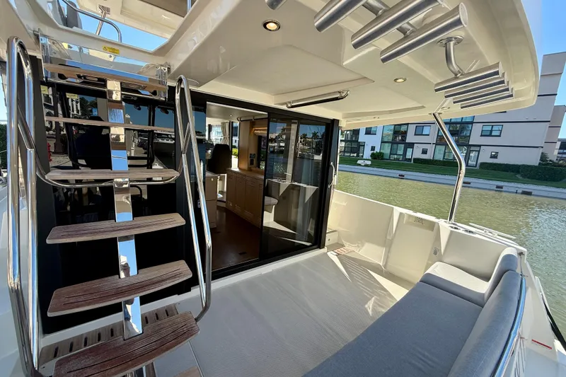 Slide: The Image of 2023 Beneteau Swift Trawler 48 interior with stairs and seating area. - 8
