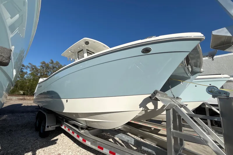 The Image of 2026 World Cat 265 CC-X boat on trailer under clear blue sky. - 0