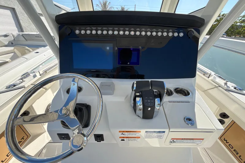 Slide: The Image of 2026 World Cat 265 CC-X boat dashboard with steering wheel and control panel. - 10