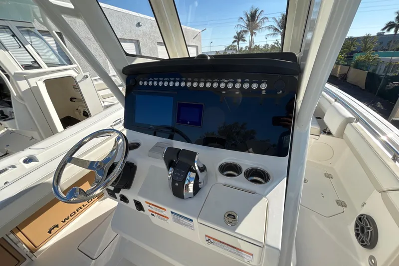 Slide: The Image of 2026 World Cat 265 CC-X boat dashboard with steering wheel and control panel. - 11