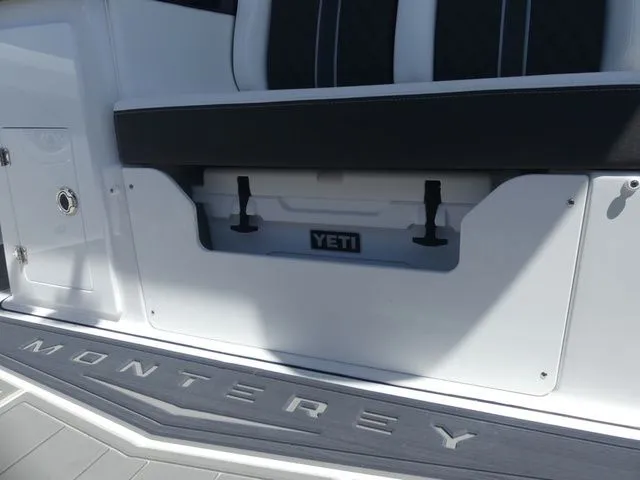 Slide: The Image of Monterey Elite 30 OB 2026 with Yeti cooler in storage compartment. - 12