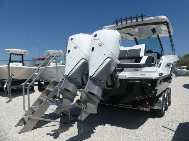 Slide: The Image of 2026 Monterey Elite 30 OB with dual outboard engines on trailer. - 5