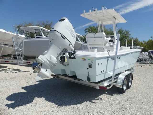 Slide: The Image of 2026 Twin Vee 220 Baycat boat on trailer outdoors. - 11
