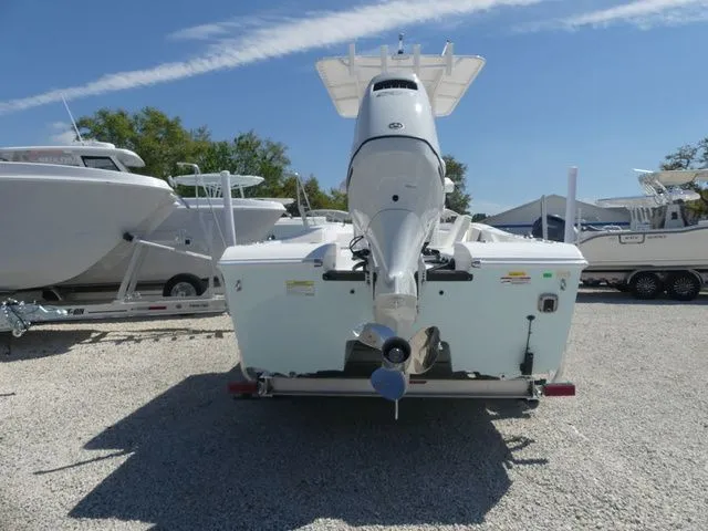 Slide: The Image of Rear view of 2026 Twin Vee 220 Baycat boat on gravel. - 4